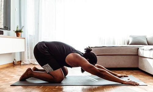 a man doing the child's pose